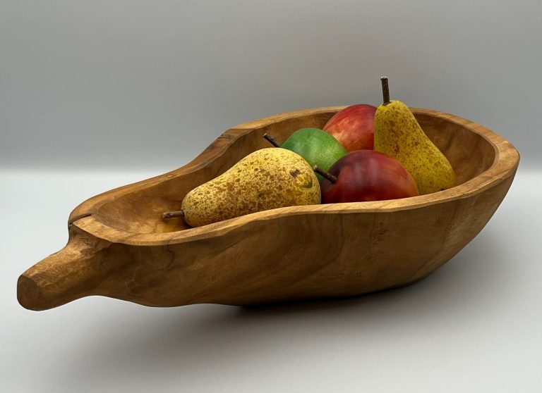 Wooden bowl containing hand painted wooden fruit.
