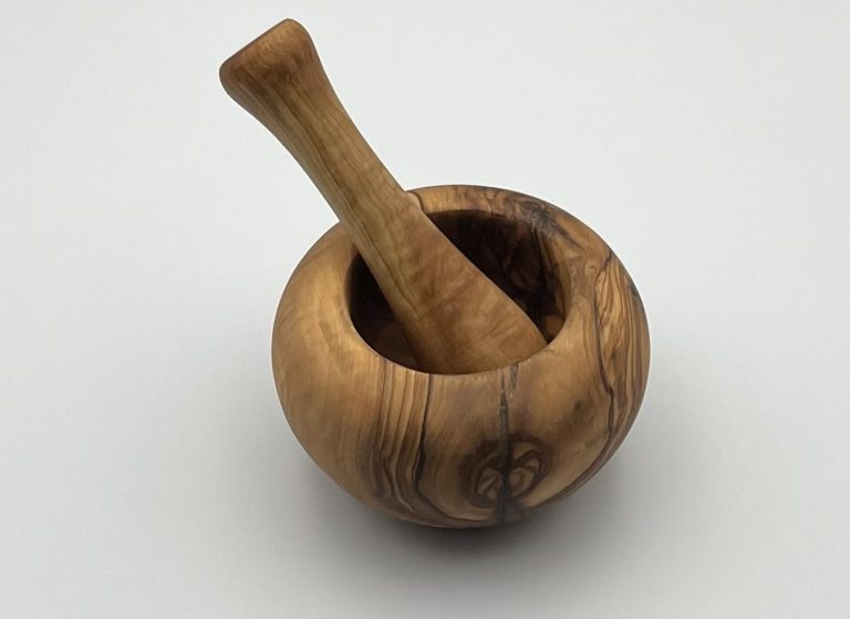 Wooden mortar and pestle set with a smooth, rounded design.