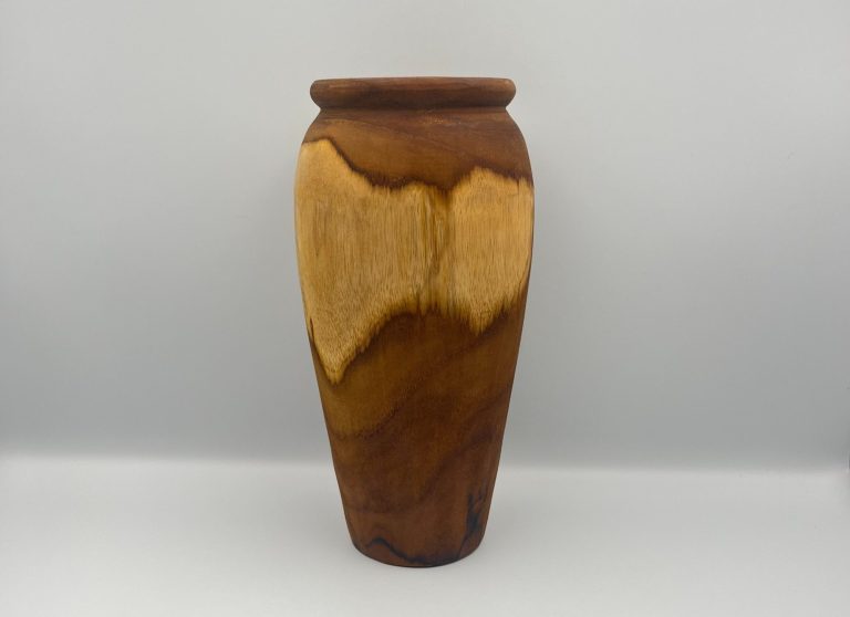 A wooden bowl filled with various hand crafted apples and pears in different colours.